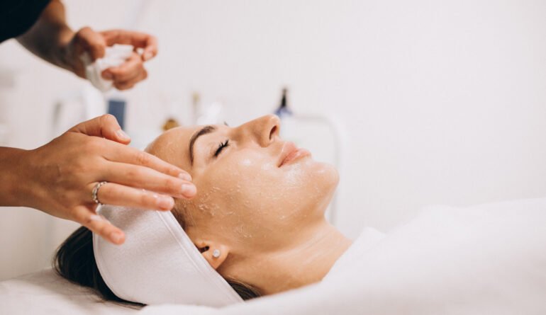 Cosmetologist cleaning face of a woman in a beauty salon Cosmetologist cleaning face of a woman in a beauty salon