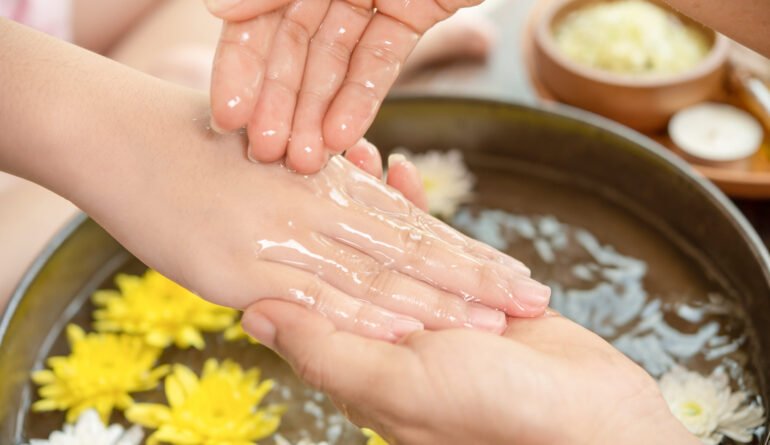 Female hands and bowl of spa water with flowers, close up. Hands Female hands and bowl of spa water with flowers, close up. Hands Spa.Manicure concept.